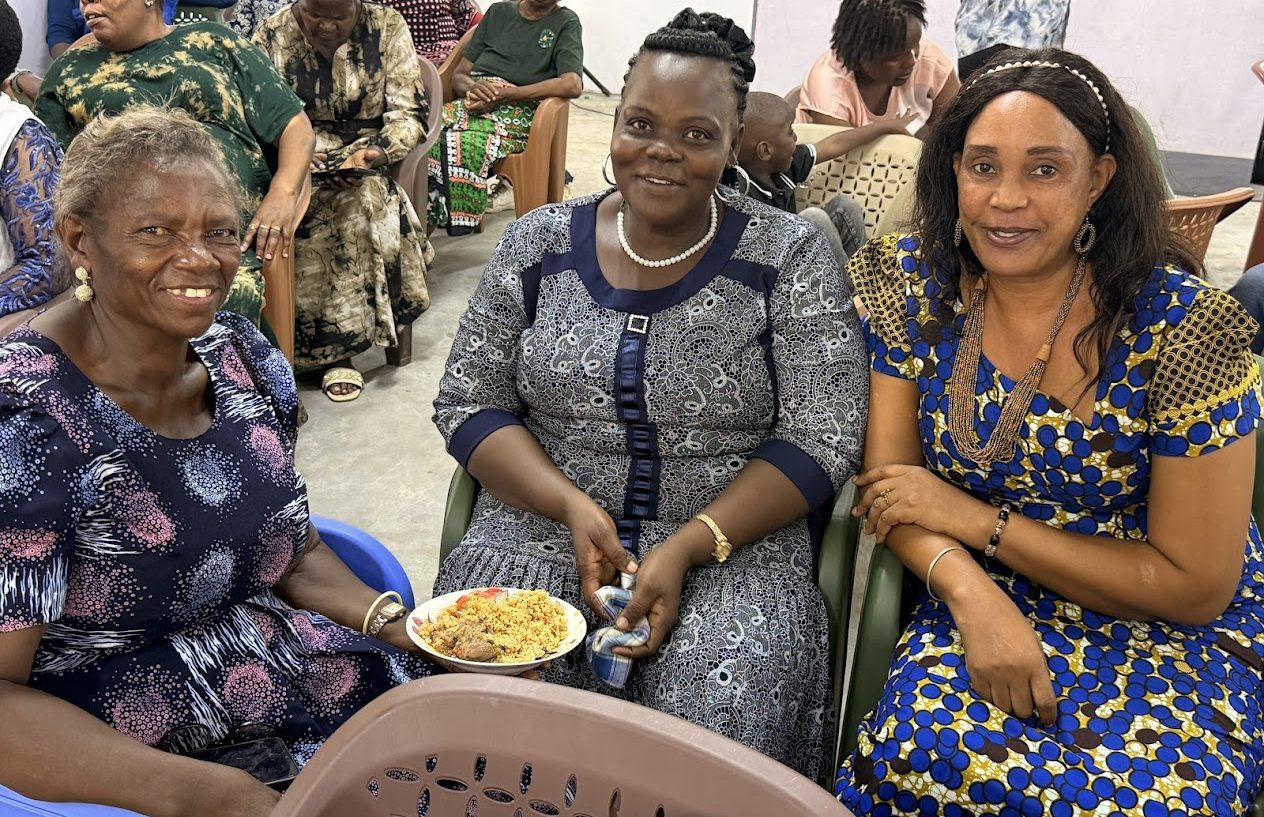 Three women sharing a meal at a summit