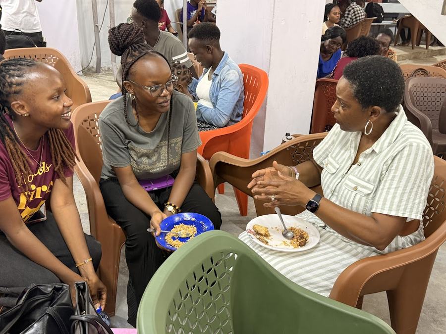Mentorship in action at the GDP Multiplex Center — women and youth sharing a meal and conversation, Mombasa 2026