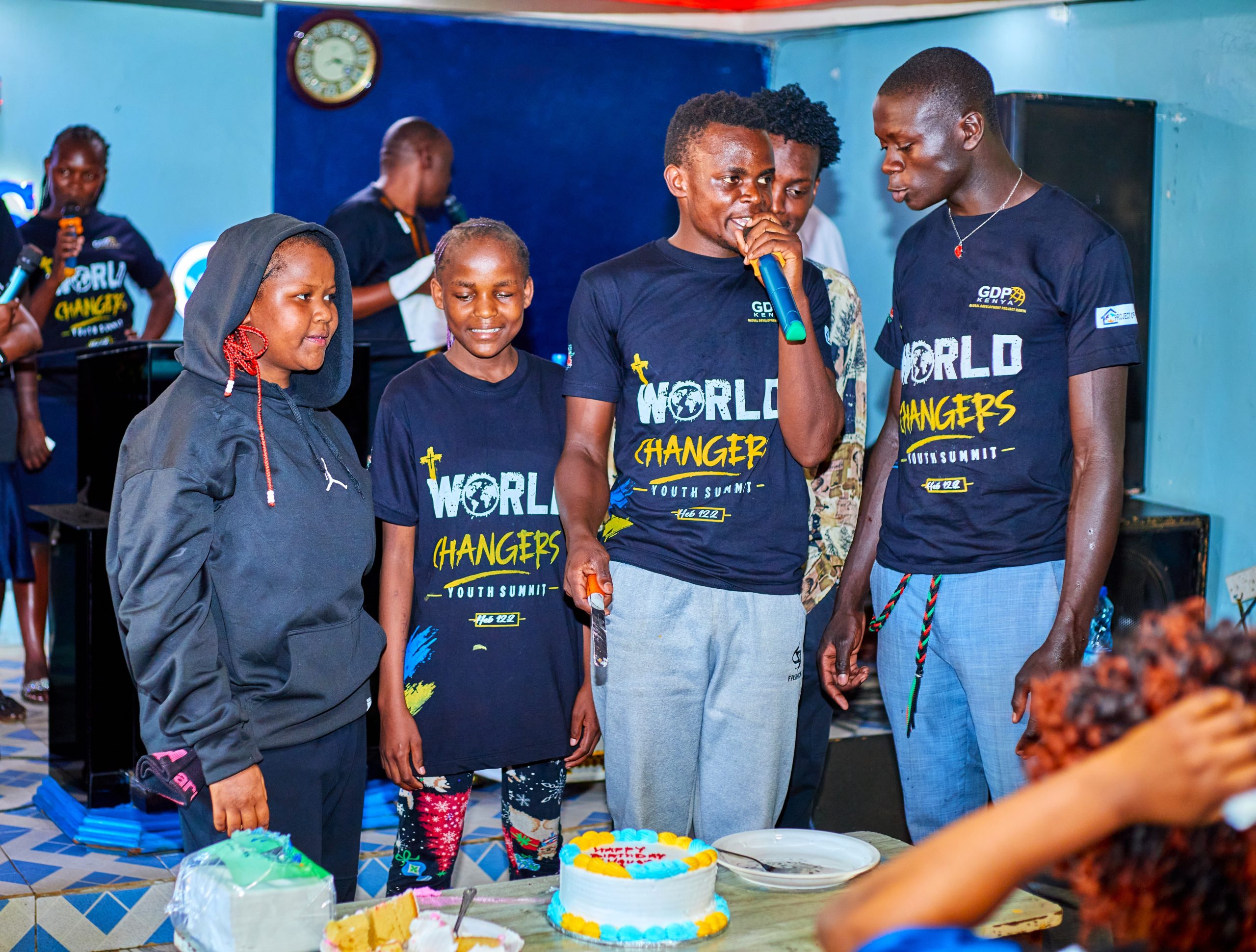 Youth leaders celebrating together with cake at a World Changers gathering