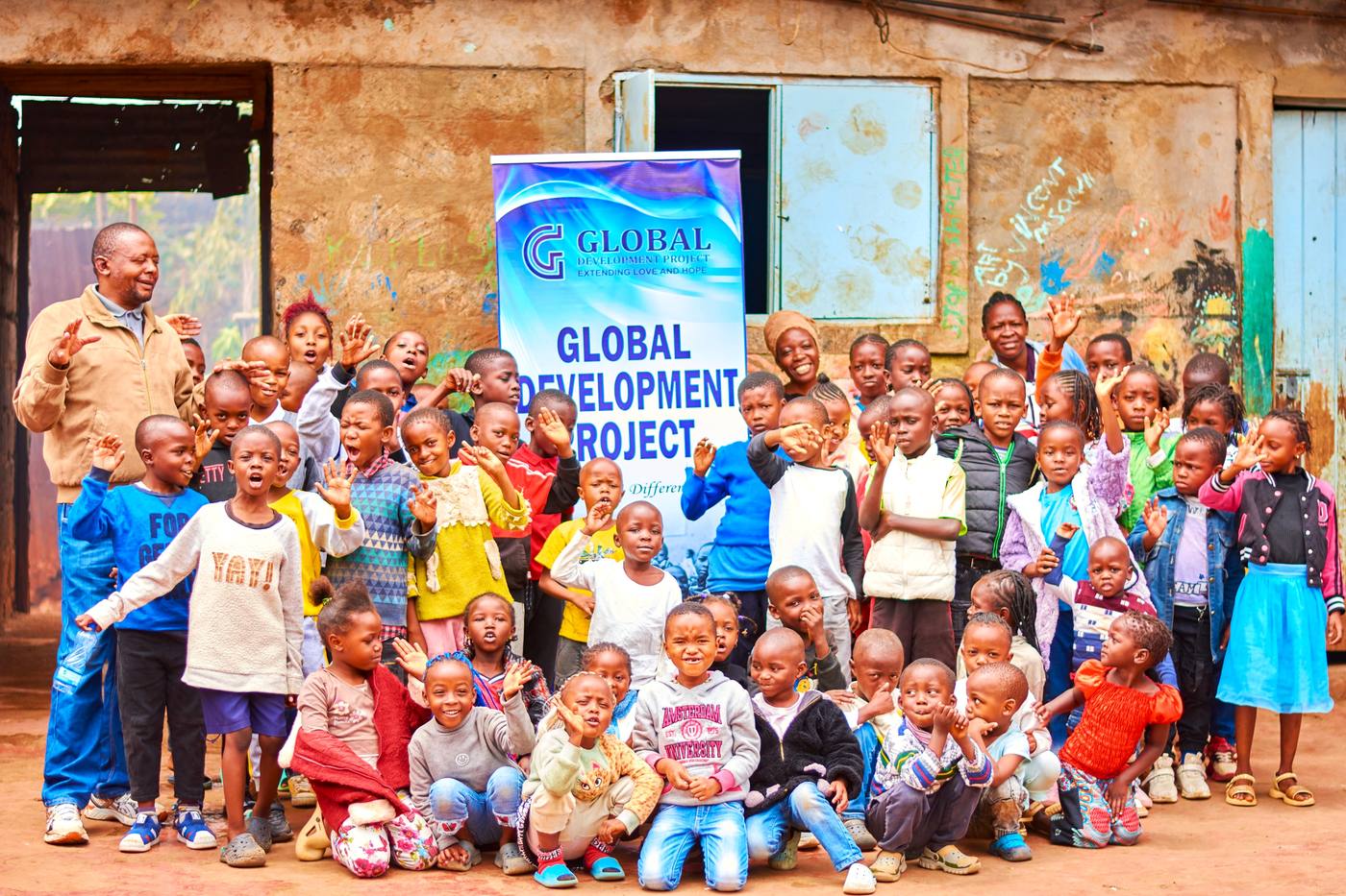Michael Wright with children outside a Global Development Project community center in Kenya