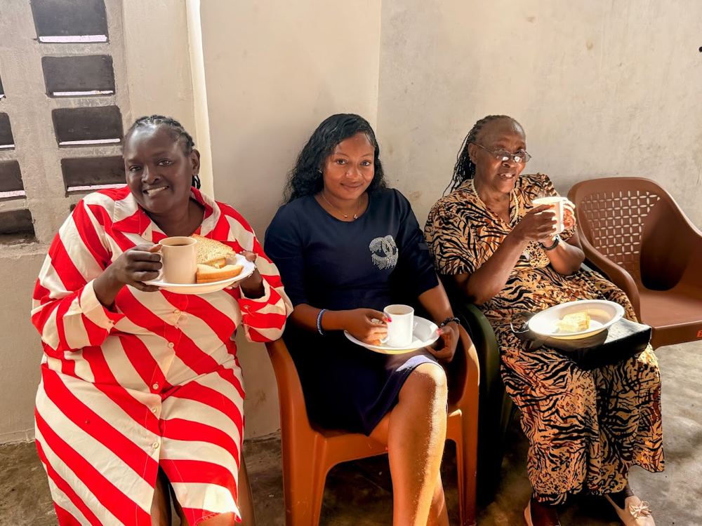 Three women enjoying tea and bread together
