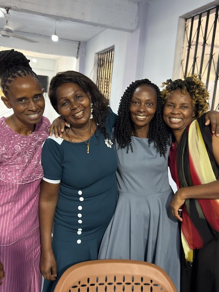 Four women smiling together at GDP Women's Empowerment event — joyful community connection, Kenya